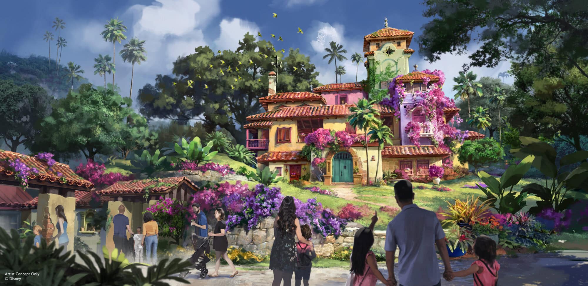 Colorful spanish-style painted house with pink, purple, and yellow walls surrounded by lush greenery and blooming flowers, with visitors walking and taking photos