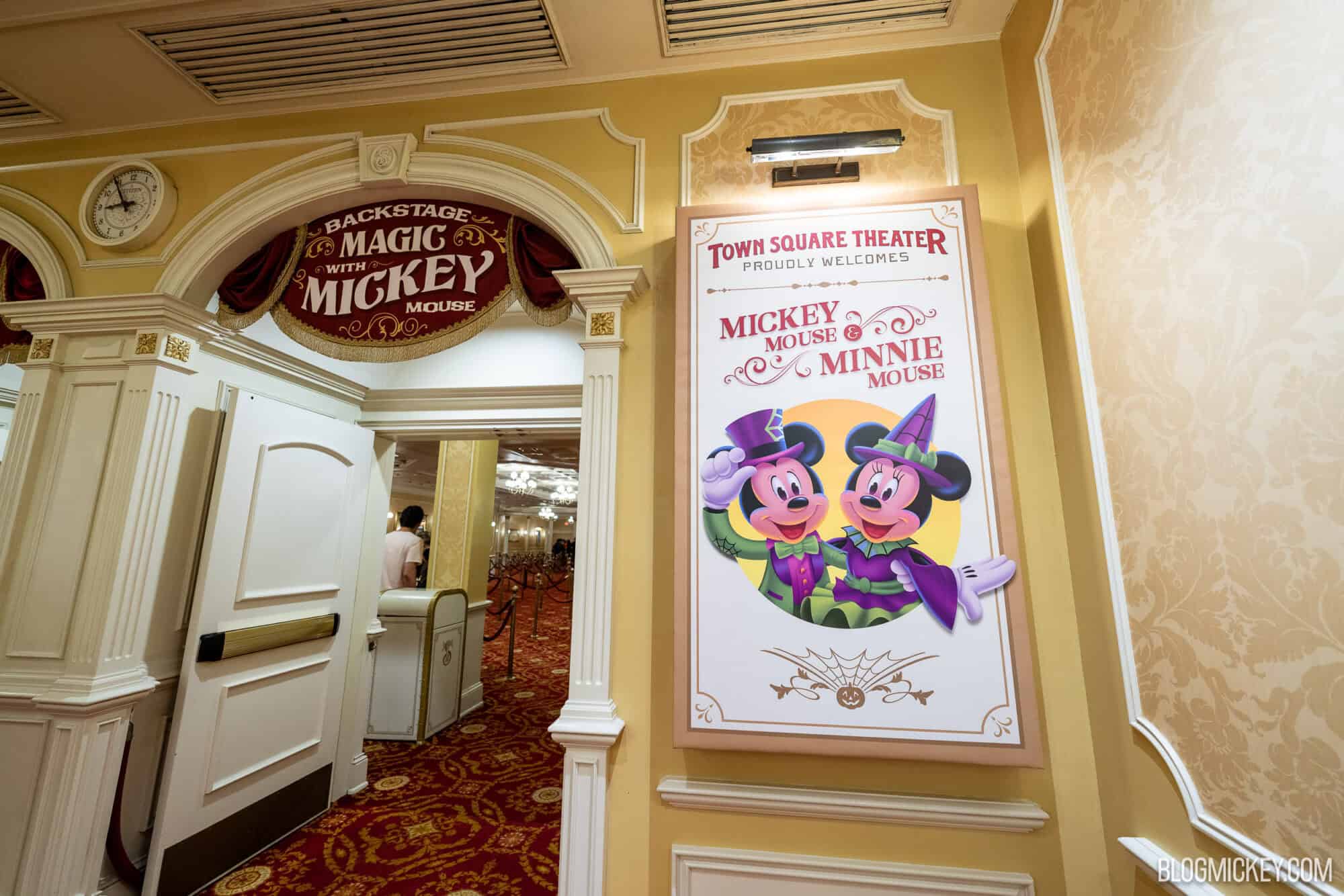 Colorful Disney Halloween party announcement poster featuring Mickey and Minnie Mouse in costumes at the Town Square Theater.
