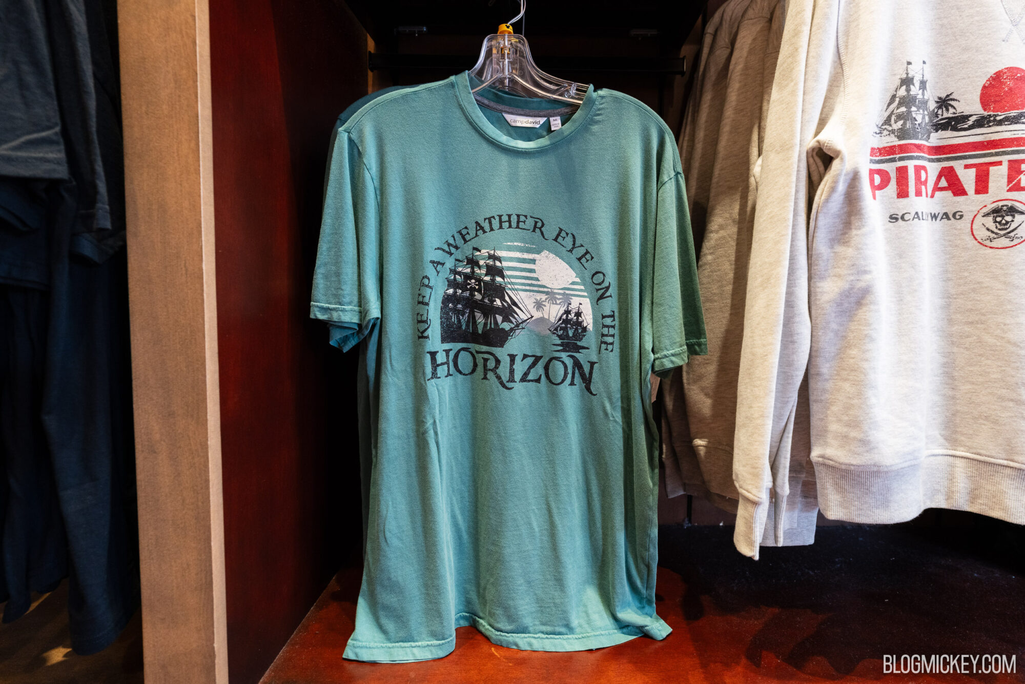 Colorful Disney-themed T-shirt with a sailing ship graphic and the phrase, "Keep an Weather Eye on the Horizon.".