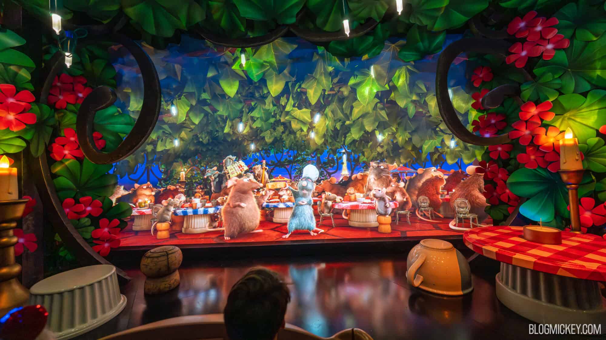 Colorful scene from the Disney movie Ratatouille show at Disney World, featuring mice and lush foliage.