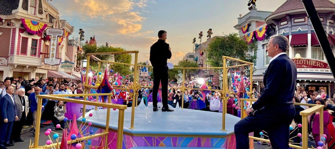 Disney World event featuring a speaker addressing the crowd during a celebration.