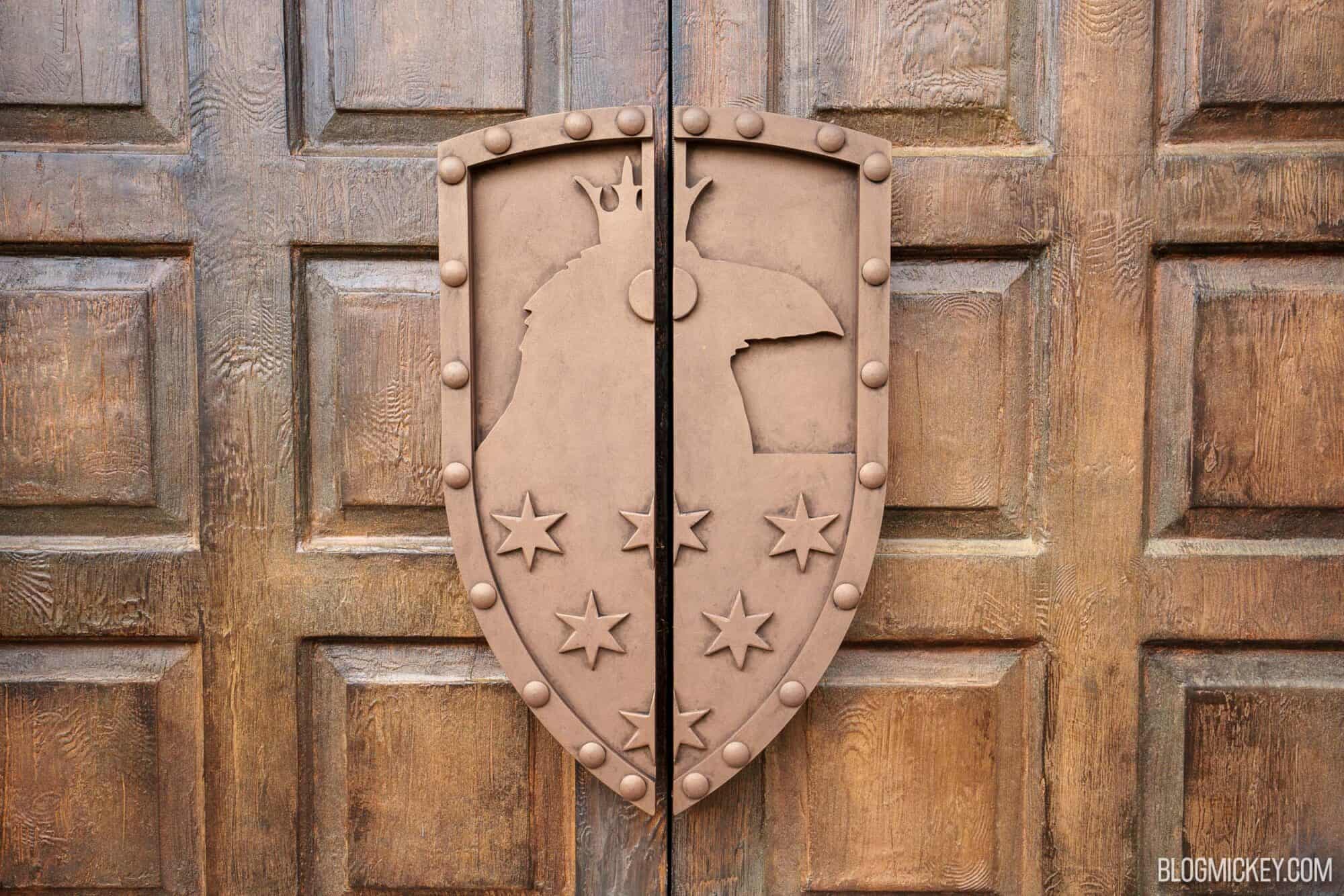 Decorative shield with stars on wooden door at Disney Springs.