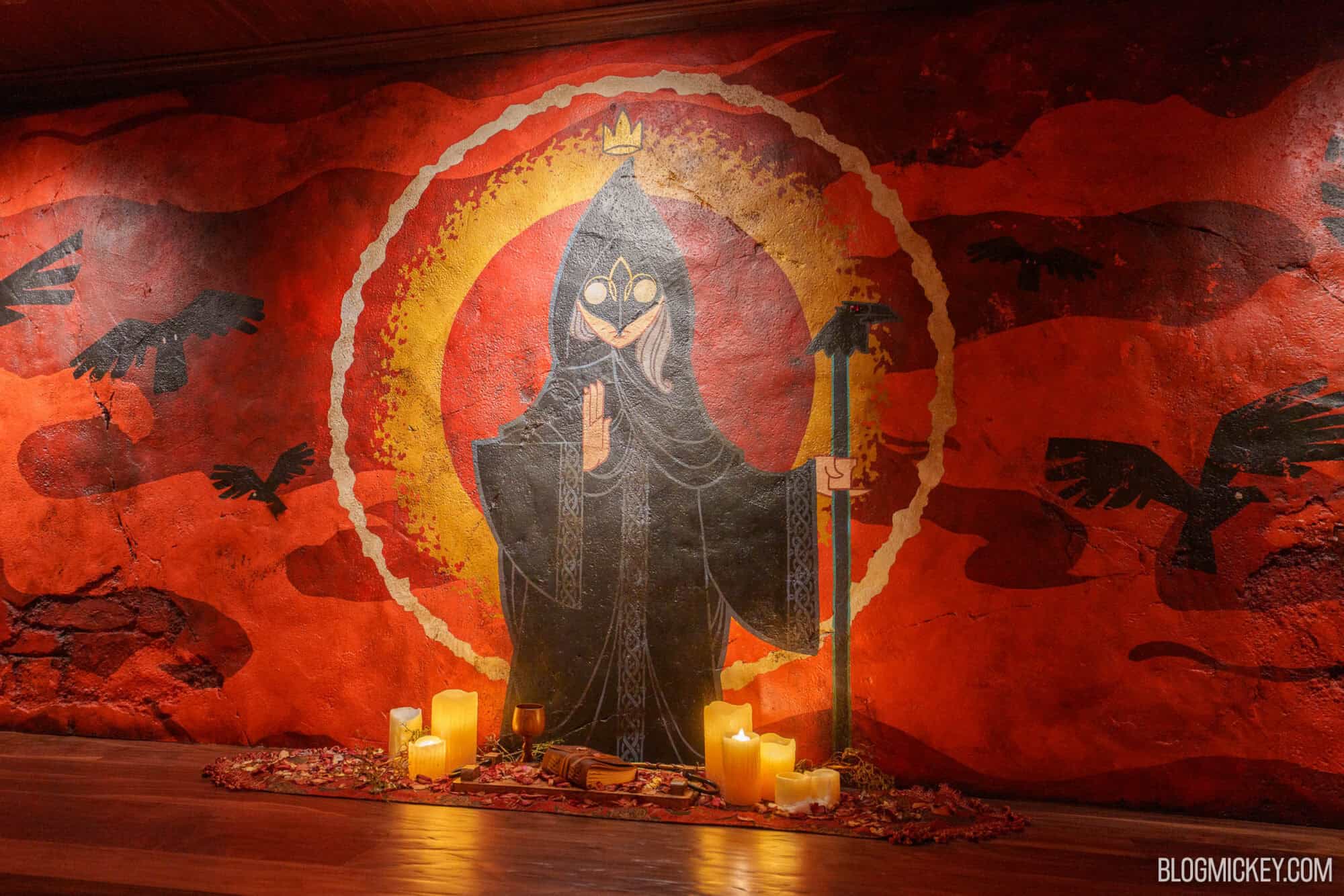 Artwork of a raven deity with candles at Disney Springs.