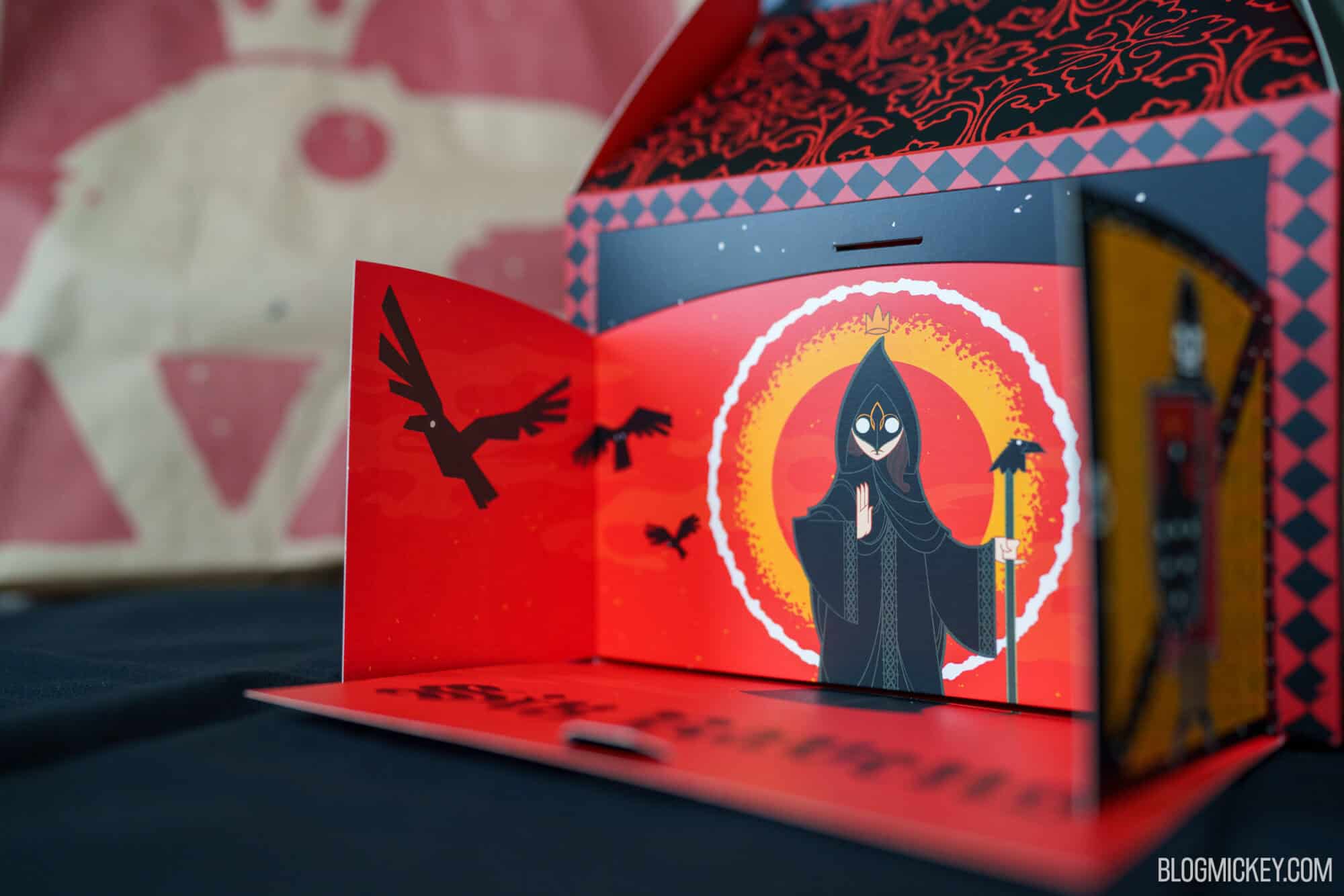 Dark wizard figure with ravens on a red and black background at Disney Springs.