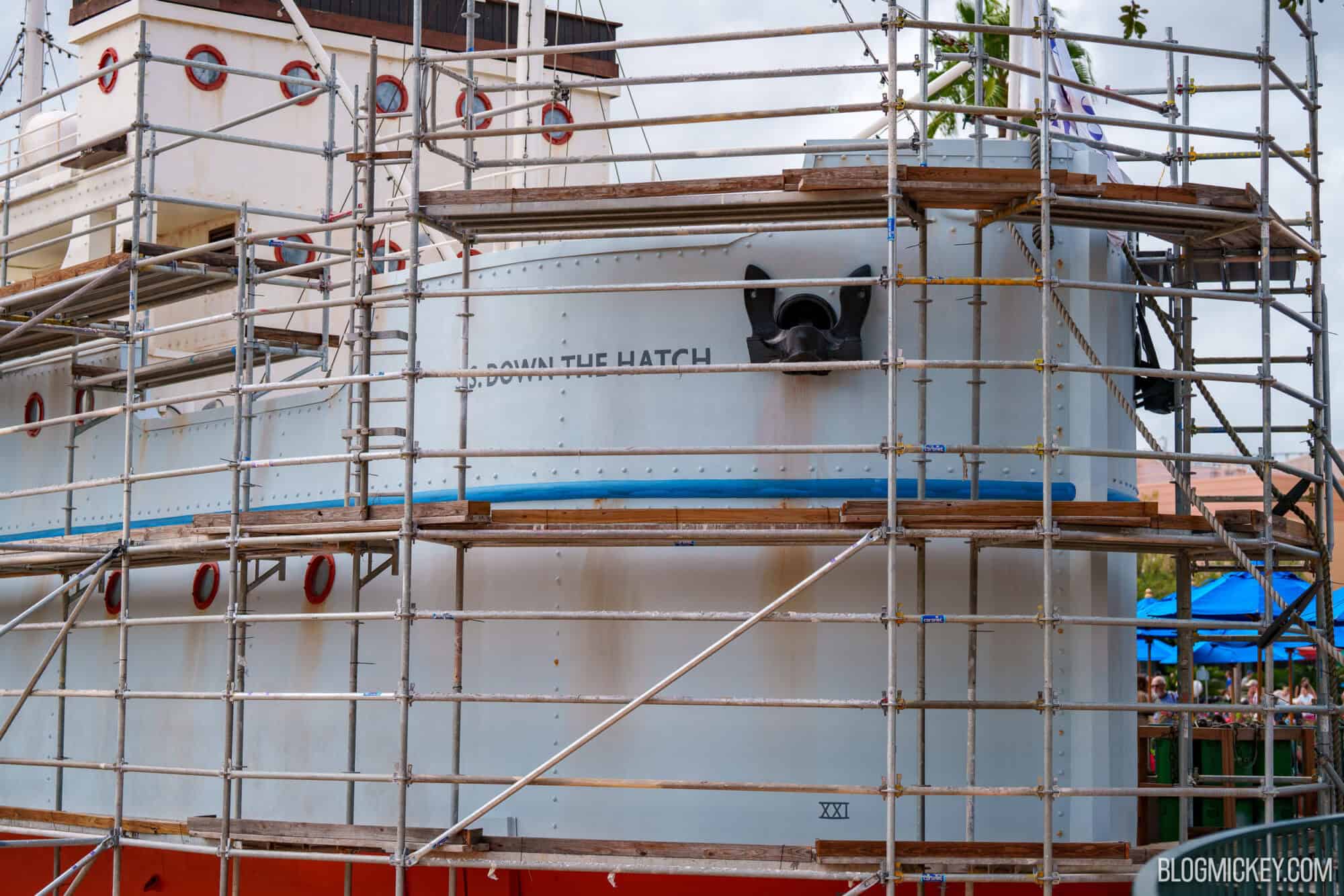 Ship at Echo Lake undergoing repainting with scaffolding around it.