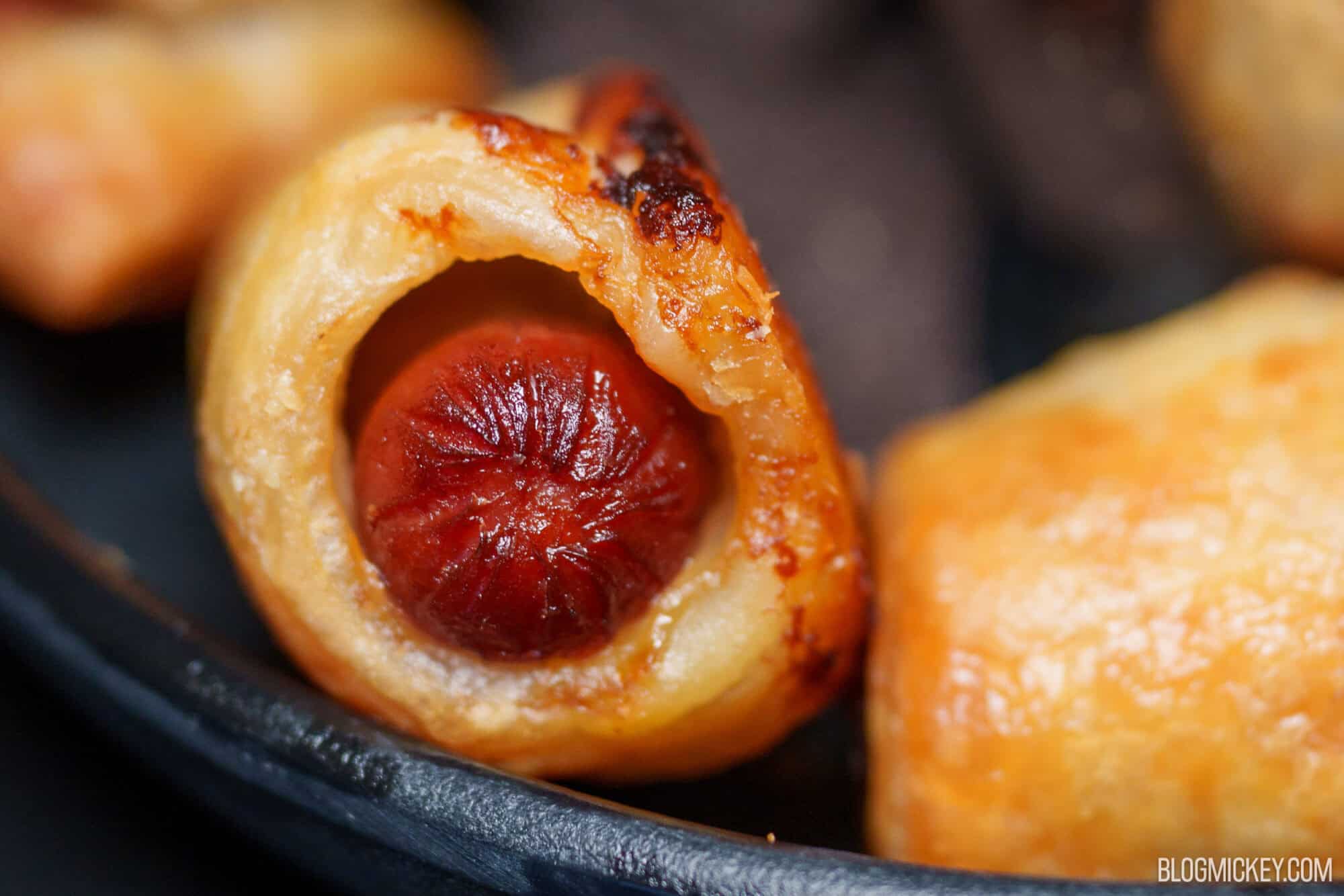 Close-up of cheese-filled pastry with a sausage inside at Magic Kingdom.