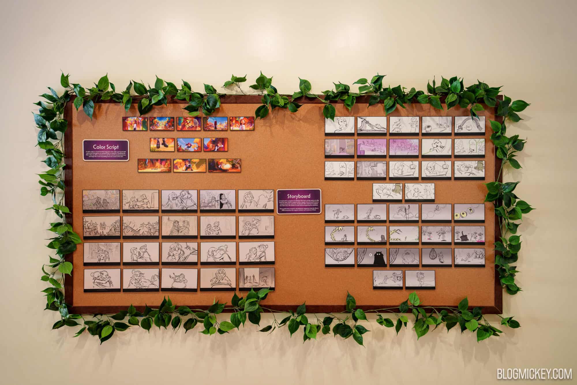 Disney character maquettes and concept art on display at Hollywood Studios board.