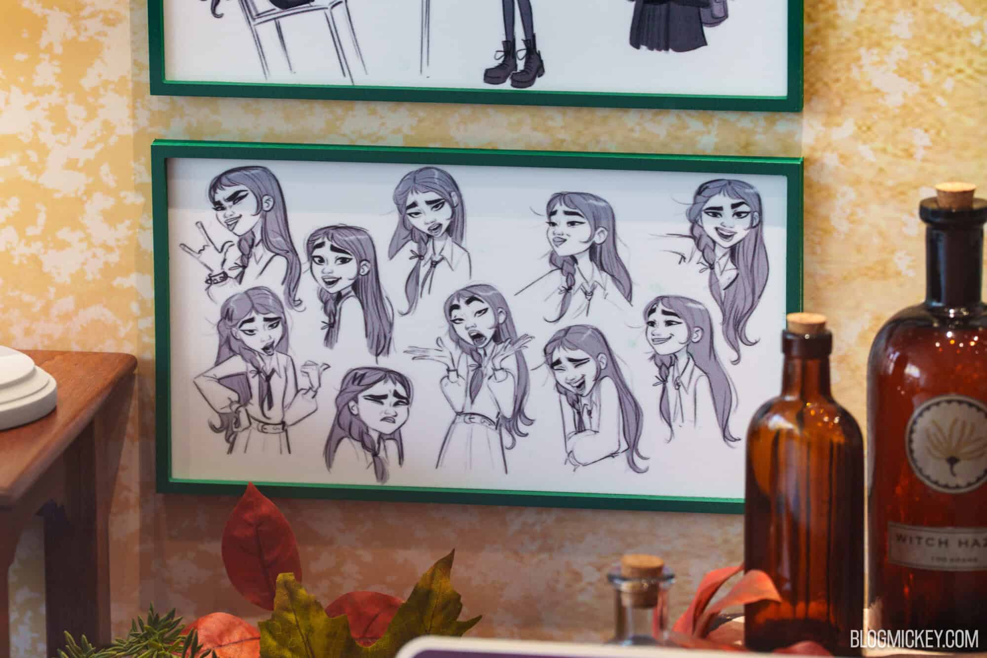 Concept art sketches of characters displayed at Hollywood Studios exhibit.