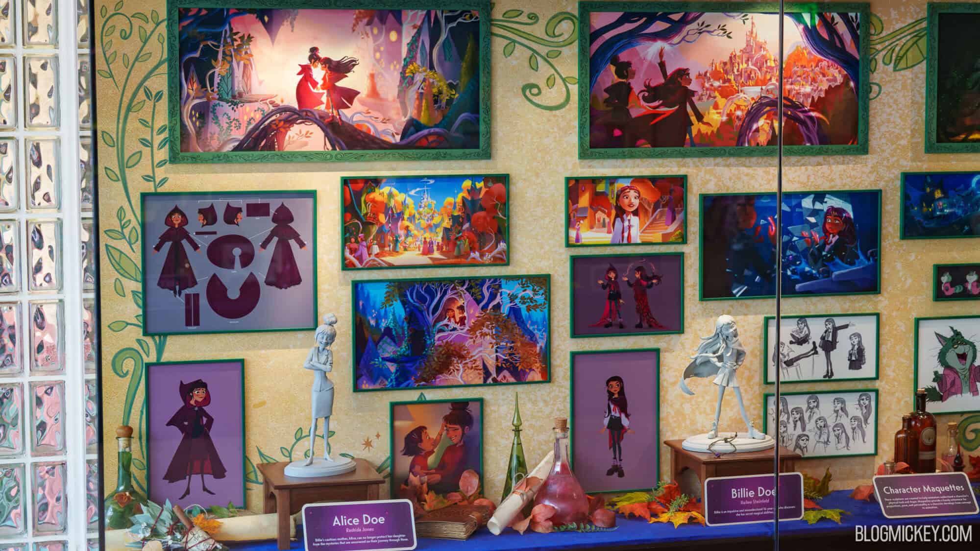 Disney character maquettes and concept art on a gallery wall at Hollywood Studios.