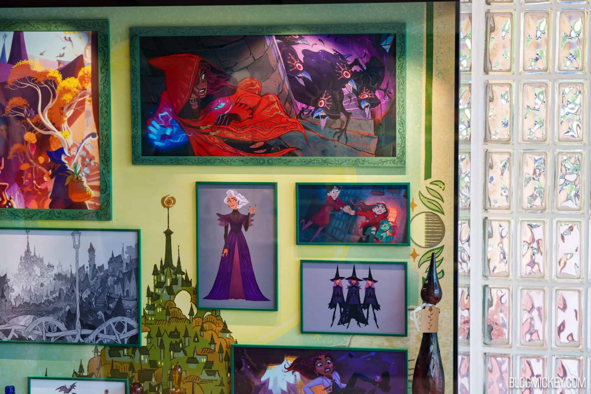 Framed concept art of hexed characters and villains on display at Hollywood Studios.