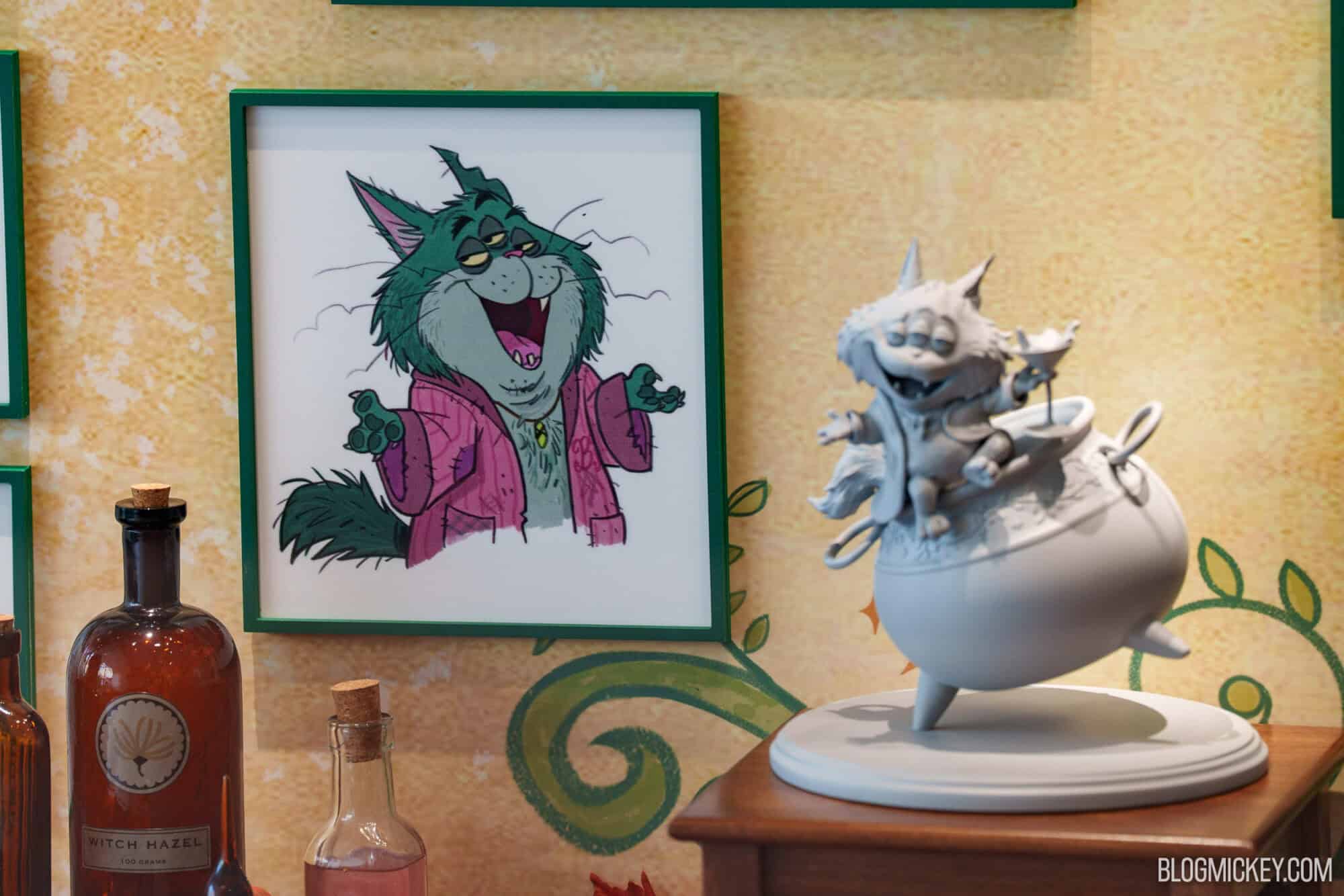 Disney character maquettes on display at Hollywood Studios featuring a caricatured cat painting and.